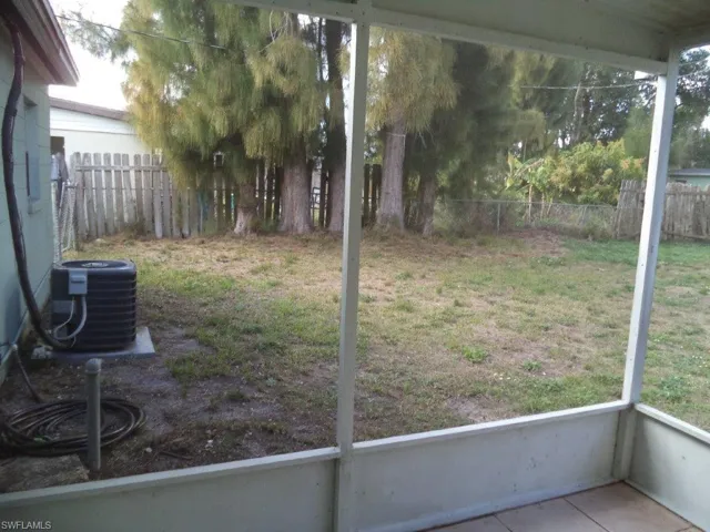 View of yard with central AC and a fenced backyard