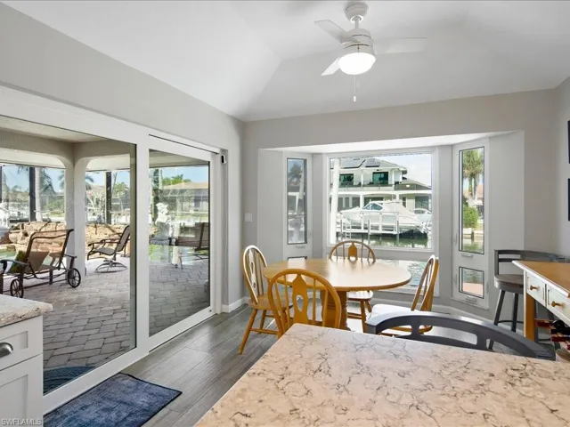 Kitchen eating area with water view, and lofted ceiling