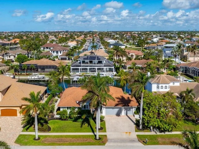 Birds eye view of property with a water view