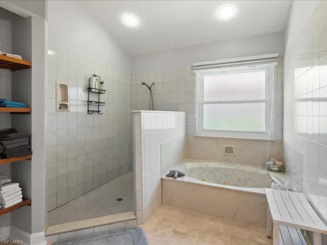Master Bathroom featuring plus walk in shower and vaulted ceiling