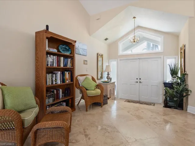 Foyer featuring high vaulted ceiling and an inviting chandelier