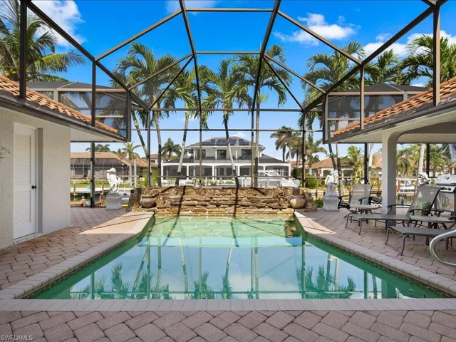 View of pool with a lanai and a patio area