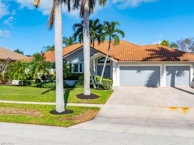 View of front of home with a garage and a front yard