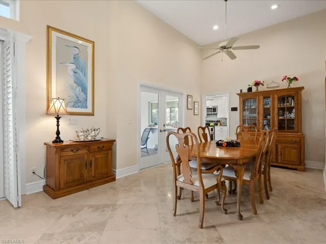 Dining space with high vaulted ceiling, french doors, and ceiling fan
