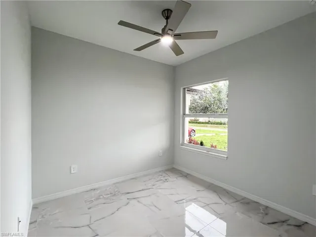 Bright interior space featuring large format marble-look tile flooring