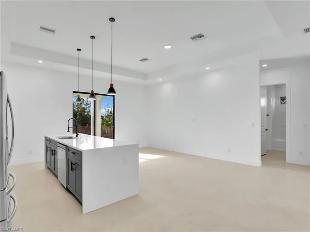 Kitchen featuring dishwashing machine, visible vents, a sink, and recessed lighting