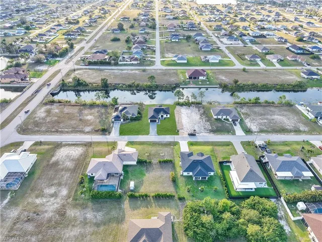 Aerial view with a water view and a residential view