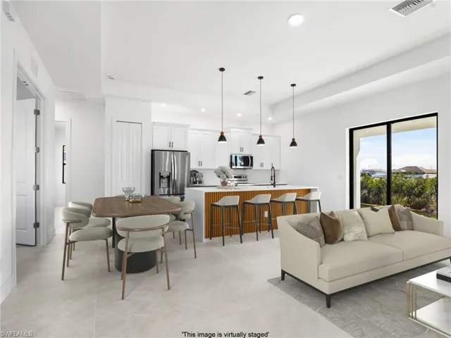 Living room with recessed lighting and visible vents