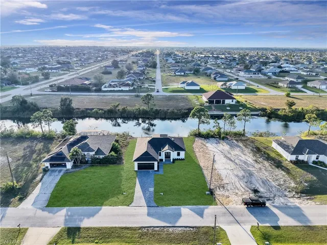Aerial view featuring a water view and a residential view