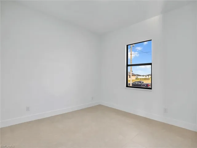 Spare room featuring baseboards
