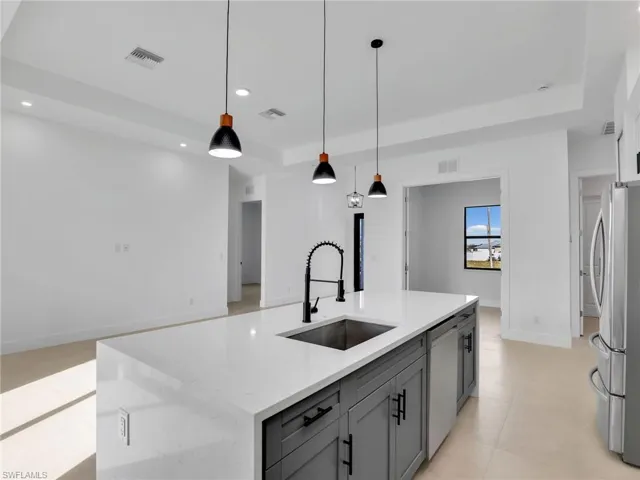 Kitchen featuring recessed lighting, a sink, visible vents, appliances with stainless steel finishes, and gray cabinets