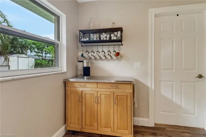 Bar with dark hardwood / wood-style flooring