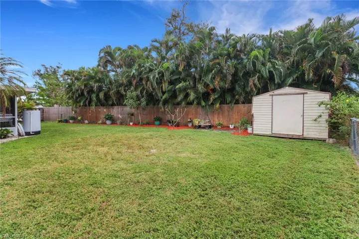 View of yard with a storage unit