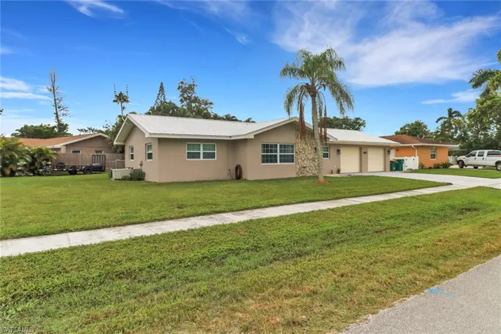 Single story home featuring a front lawn and a garage