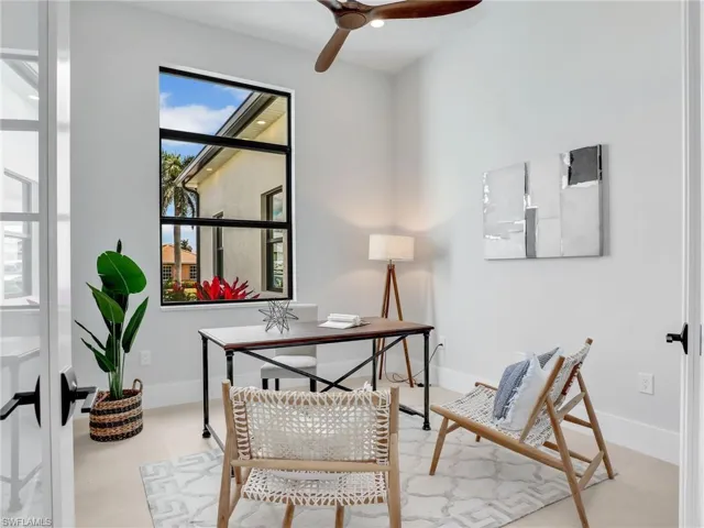Office space with a ceiling fan and baseboards
