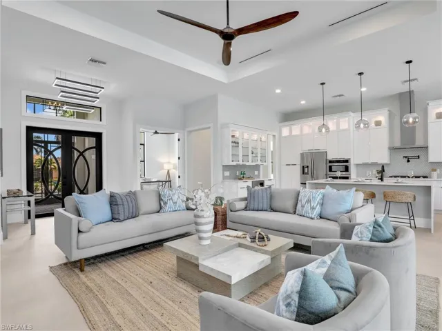 Living area featuring a ceiling fan, recessed lighting, and visible vents
