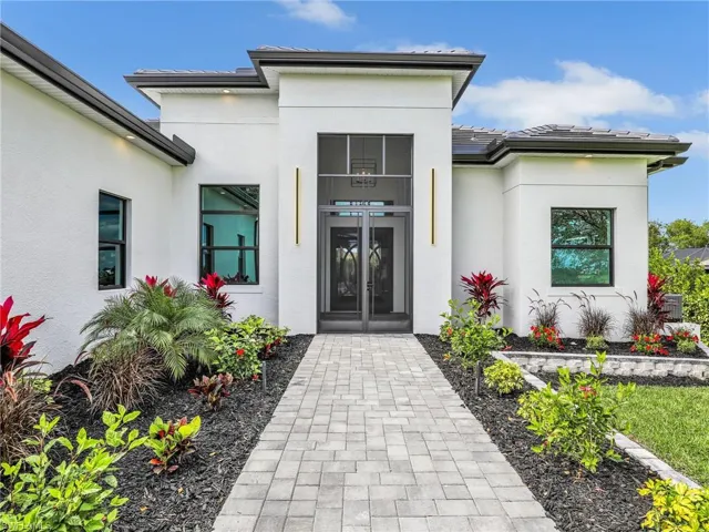 Doorway to property featuring stucco siding
