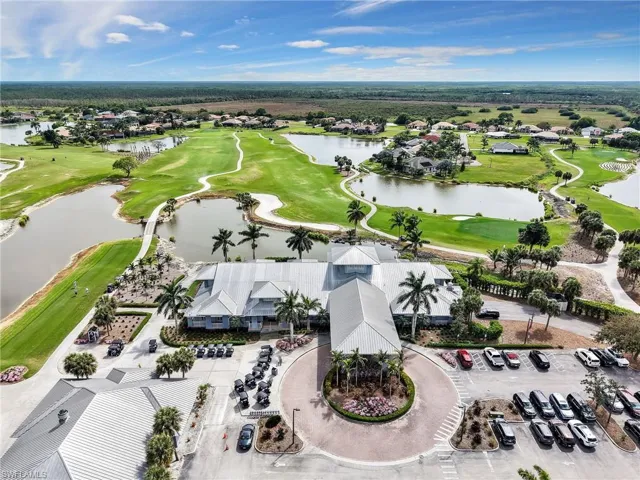 Aerial view with view of golf course and a water view