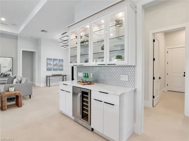 Bar featuring wine cooler, recessed lighting, visible vents, baseboards, and tasteful backsplash