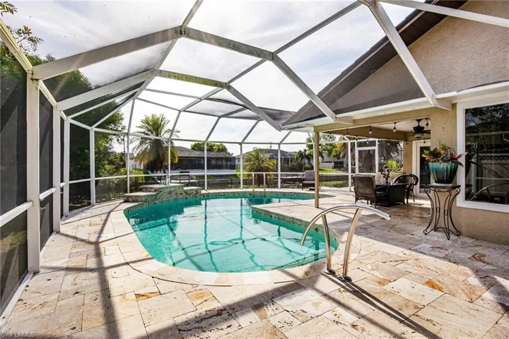Swimming pool with a patio area, a lanai, and a sunroom