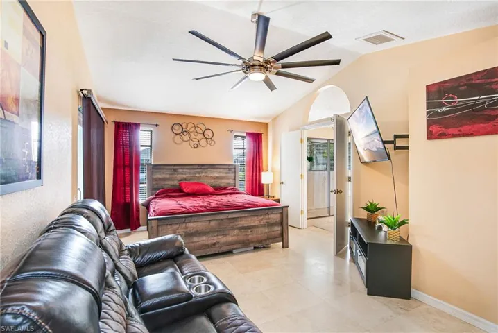 Bedroom featuring ceiling fan and vaulted ceiling