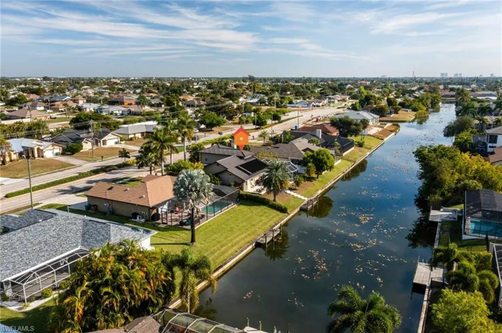 Aerial perspective of suburban area featuring a large body of water