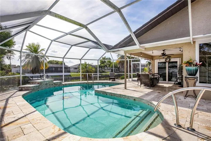 Outdoor pool featuring a patio area, glass enclosure, and a sunroom
