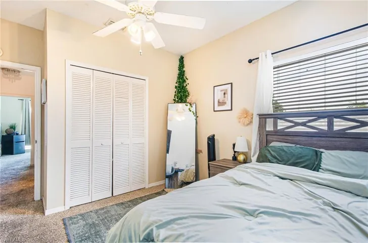 Bedroom with carpet, a closet, and ceiling fan