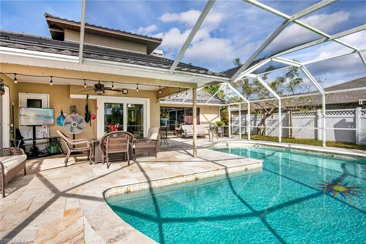 View of pool with a lanai, a patio area, a sunroom, and outdoor lounge area
