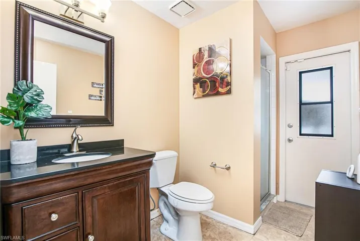 Full bath featuring vanity, a shower stall, and light tile patterned flooring
