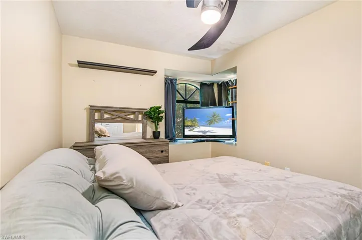 Bedroom featuring ceiling fan and a textured ceiling