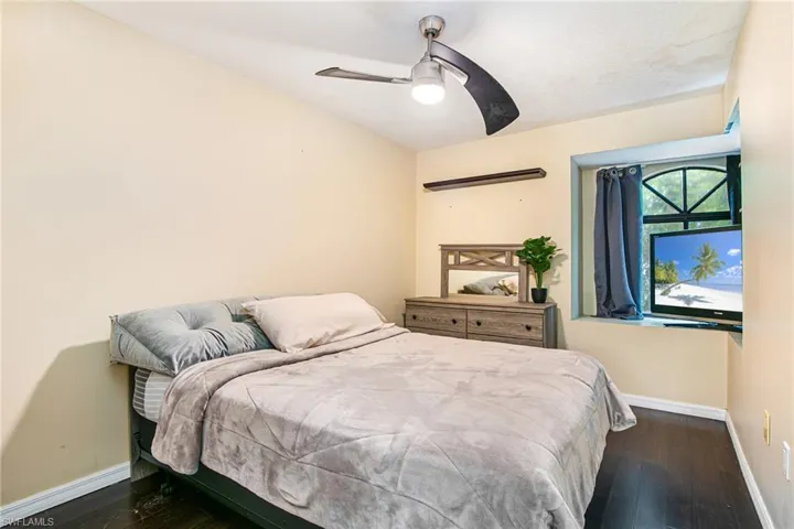 Bedroom featuring dark wood finished floors and ceiling fan