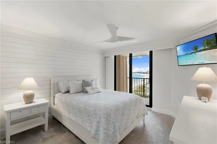 Guest bedroom, shiplap wall, high impact slider to lanai and fabulous view