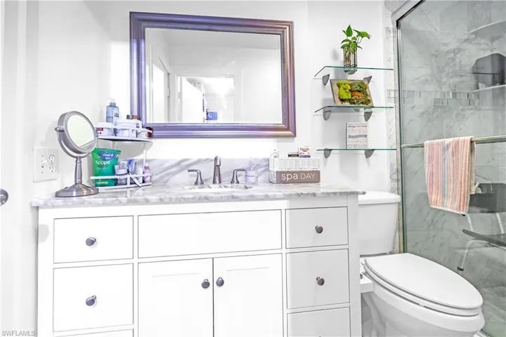 White vanity featuring brushed nickel hardware