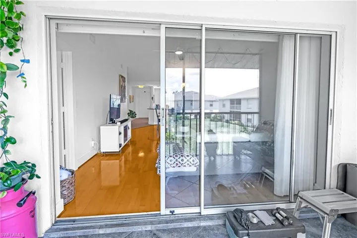 Expansive sliding glass doors opening to an outdoor patio with textured tile flooring