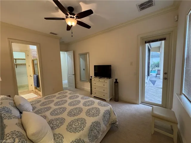 Bedroom featuring light carpet, access to outside, visible vents, and ornamental molding