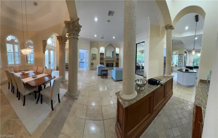 Dining space featuring recessed lighting, visible vents, ornate columns, a glass covered fireplace, and crown molding