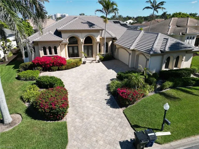 Mediterranean / spanish home featuring a garage, a tile roof, and stucco siding