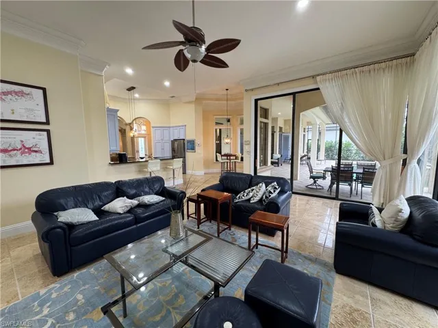 Living room with a ceiling fan, baseboards, crown molding, and recessed lighting