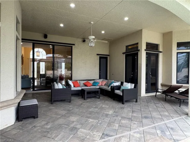 View of patio with a ceiling fan and an outdoor hangout area