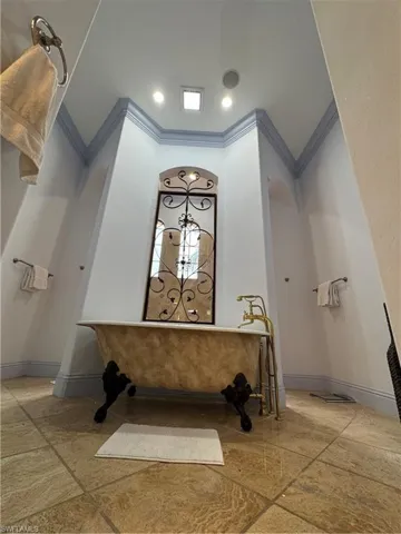 Bathroom featuring recessed lighting, baseboards, and ornamental molding