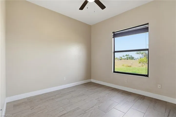 Bedroom featuring baseboards and ceiling fan