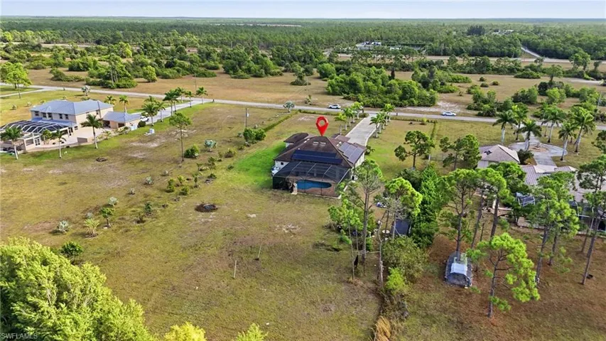 Overview of rural landscape featuring a heavily wooded area