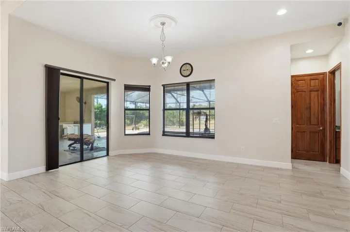 Dining room with a chandelier and recessed lighting