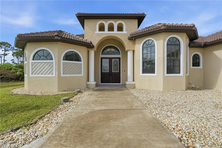 Property entrance with stucco siding and a tile roof