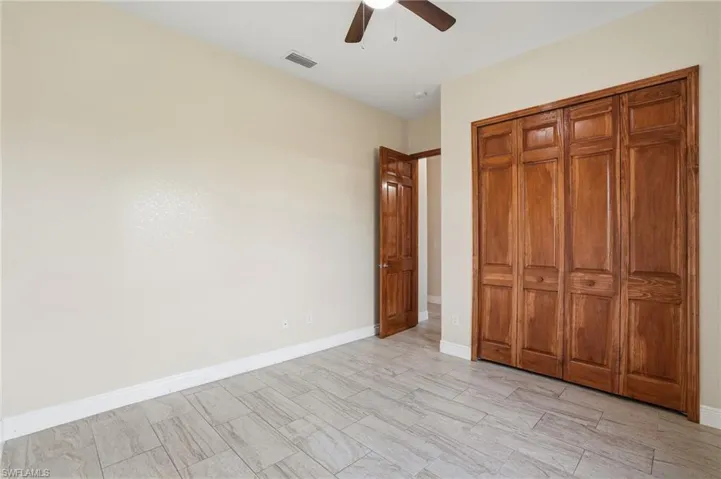 Bedroom featuring ceiling fan and a closet