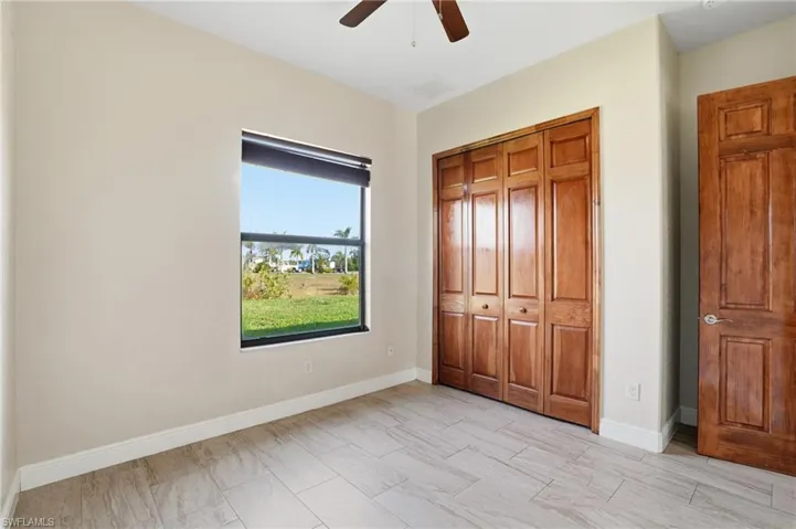 Bedroom with ceiling fan and a closet