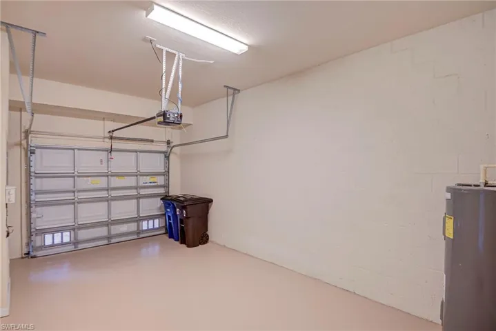 Garage with water heater and a garage door opener
