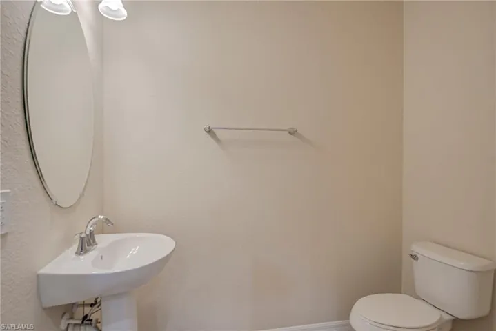 Bathroom with toilet and baseboards