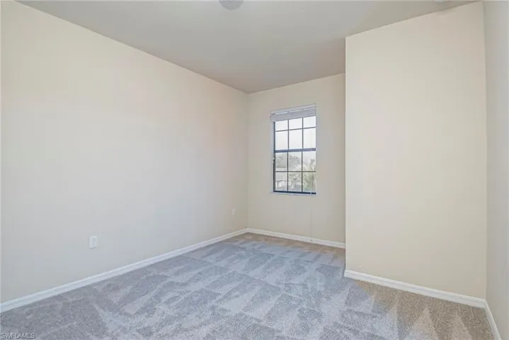 Carpeted empty room with baseboards